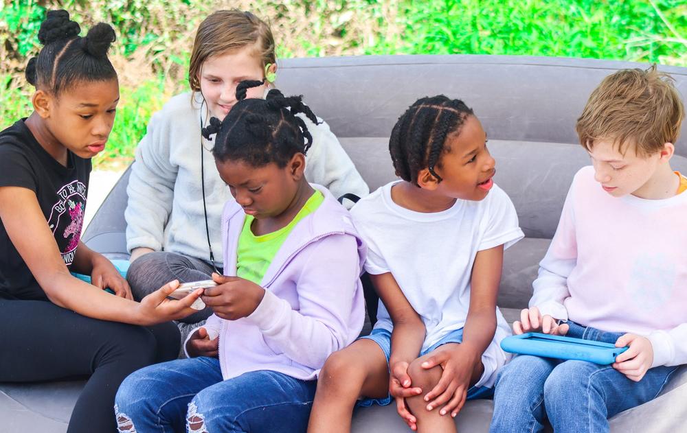 A group of five children talking