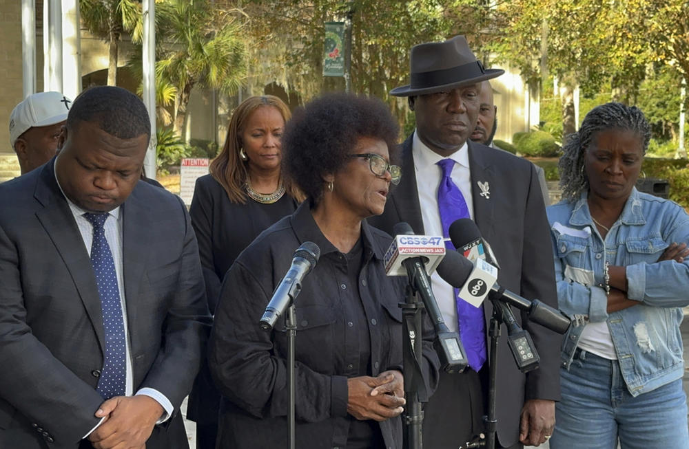 Mary Cure speaks to reporters flanked by her family's attorneys, Harry Daniels, left, and Ben Crump, right, at a news conference Tuesday, Dec. 5, 2023, in Woodbine, Georgia, announcing their intention to file suit against the Camden County Sheriff's Office for the death of her son, Leonard Cure. A deputy fatally shot Leonard Cure after pulling him over on suspicion of speeding and reckless driving, Oct. 17, 2023.