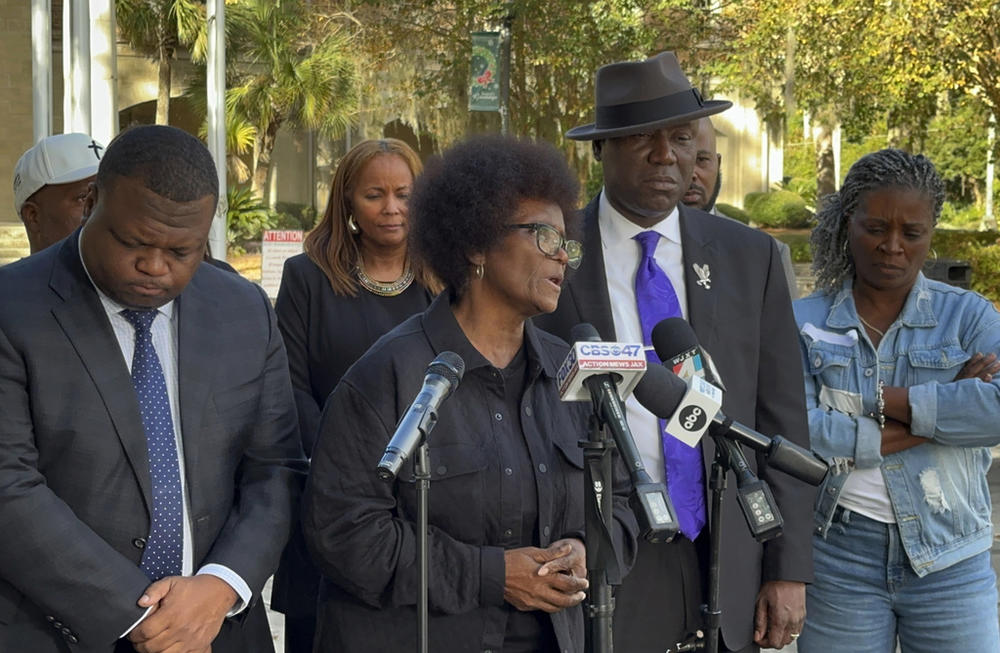 Mary Cure speaks to reporters flanked by her family's attorneys, Harry Daniels, left, and Ben Crump, right, at a news conference Tuesday, Dec. 5, 2023, in Woodbine, Georgia, announcing their intention to file suit against the Camden County Sheriff's Office for the death of her son, Leonard Cure. A deputy fatally shot Leonard Cure after pulling him over on suspicion of speeding and reckless driving, Oct. 17, 2023. 