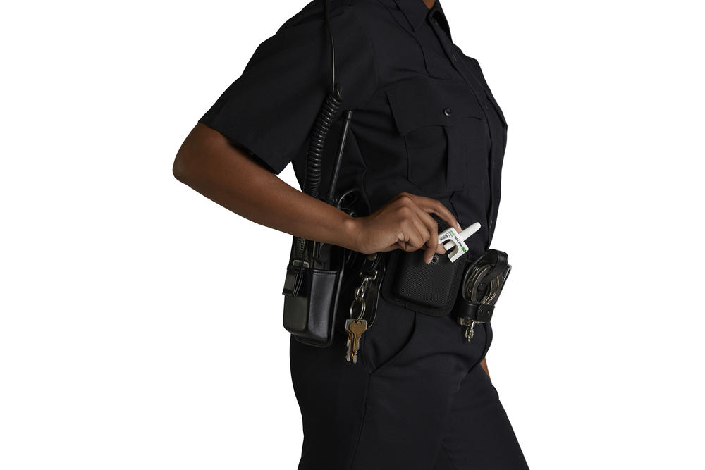 A stock image of a person with nasal nalmefene spray in a utility belt.