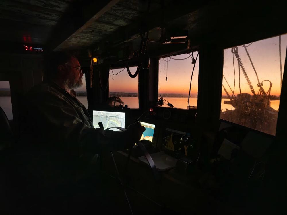 As day breaks, Captain Wynn Gale of Darien, GA steers his boat to the shrimping grounds off of Georgia’s coast. Credit: Justin Taylor/The Current