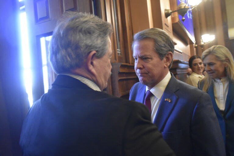Gov. Brian Kemp greets Rep. Alan Powell after eulogizing Rep. Richard Smith in the House. Ross Williams/Georgia Recorder