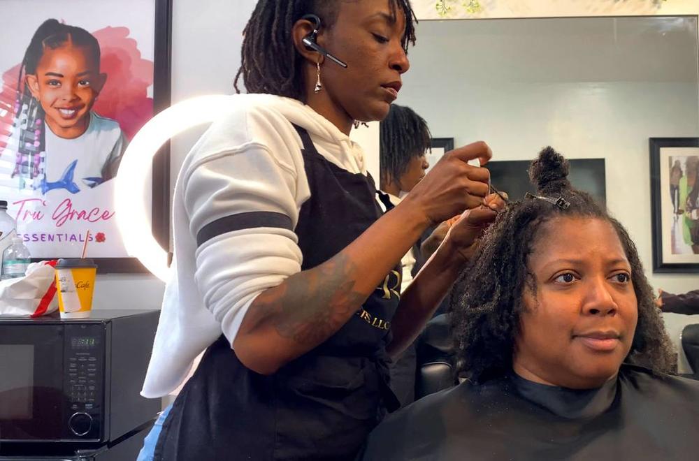 Taniesa Taylor, the owner of Locs, Twists, Braids and Crochets in Columbus, Georgia styles Shawnitra Williams’ hair recently. 01/11/2024 Mike Haskey mhaskey@ledger-enquirer.com  