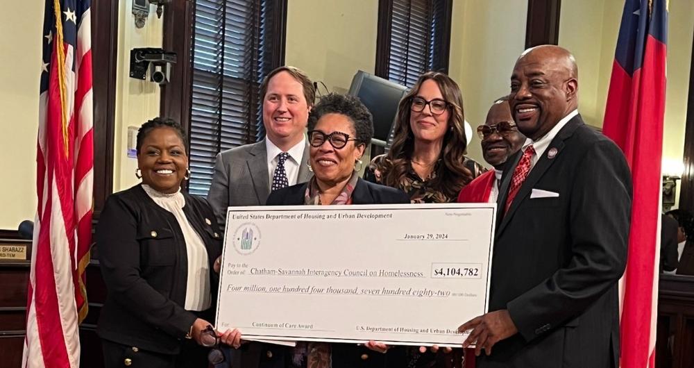 U.S. Secretary of Housing and Urban Development Marcia Fudge, center, presents a ceremonial check at Savannah City Hall, corresponding to $4.1 million in HUD funding for the Chatham-Savannah Interagency Council on Homelessness.