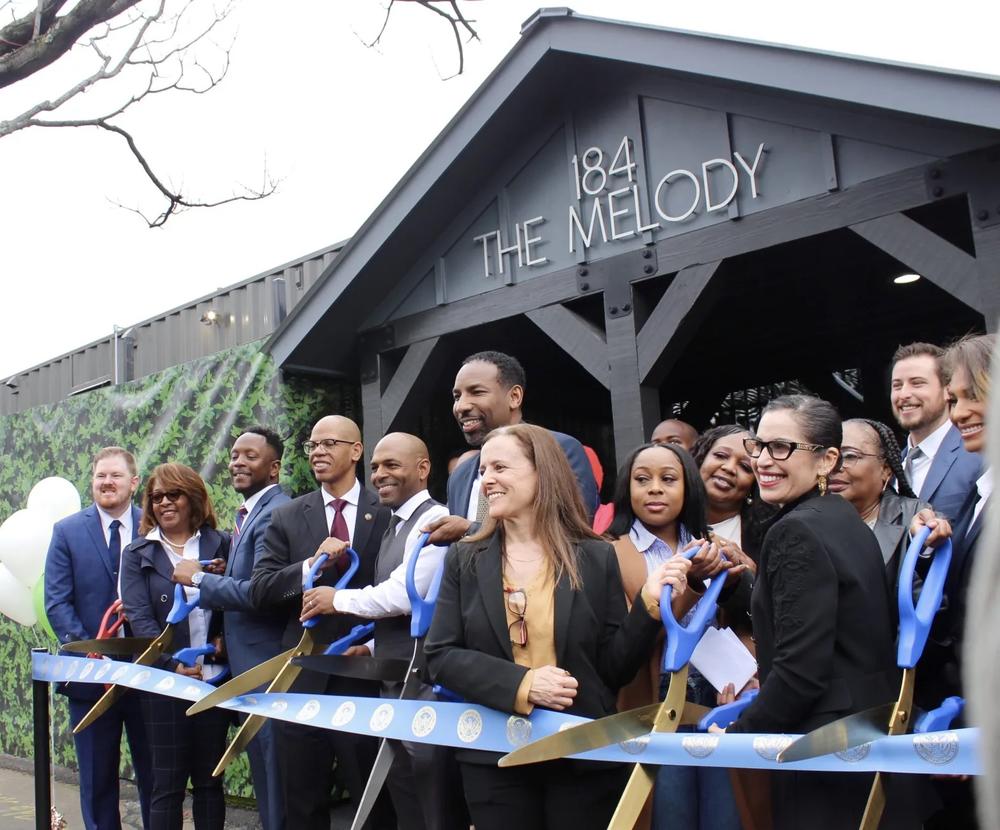 Mayor Andre Dickens (center) at a ribbon-cutting event.