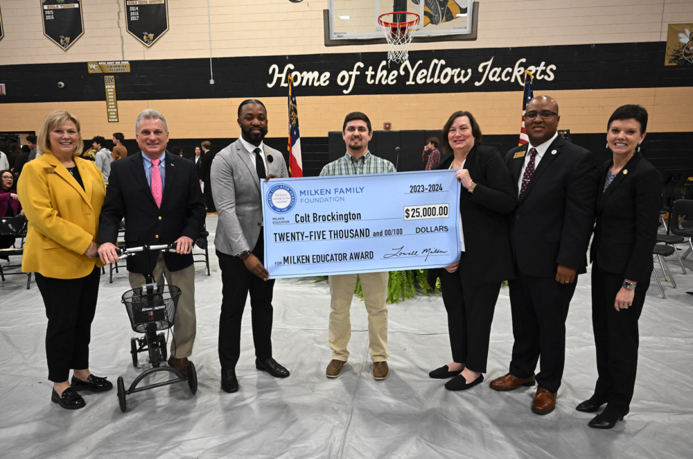 Colt Brockington holds his $25,000 check from the Milken Family Foundation