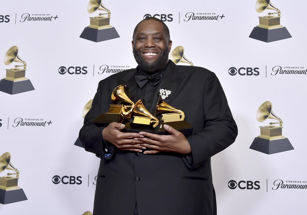 Killer Mike poses in the press room with the awards for best rap performance and best rap song for "Scientists & Engineers," and best rap album for "Michael" during the 66th annual Grammy Awards on Sunday, Feb. 4, 2024, in Los Angeles.