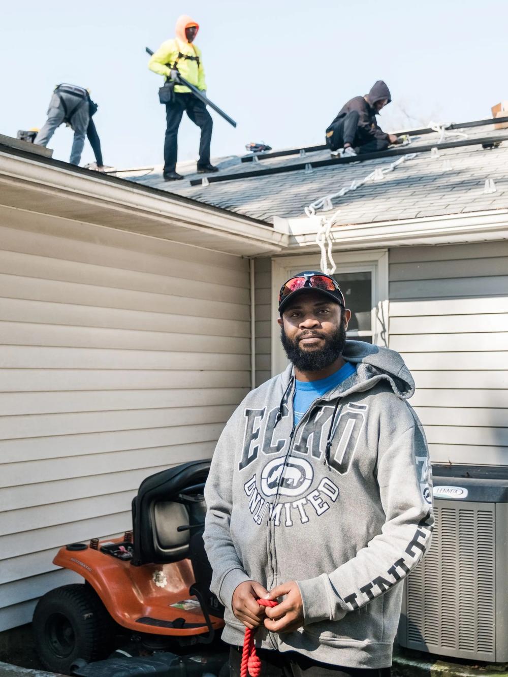Homeowner David Morgan watches as solar panels are installed on his roof, Feb. 6, 2024, Garden City. Credit: Justin Taylor/The Current