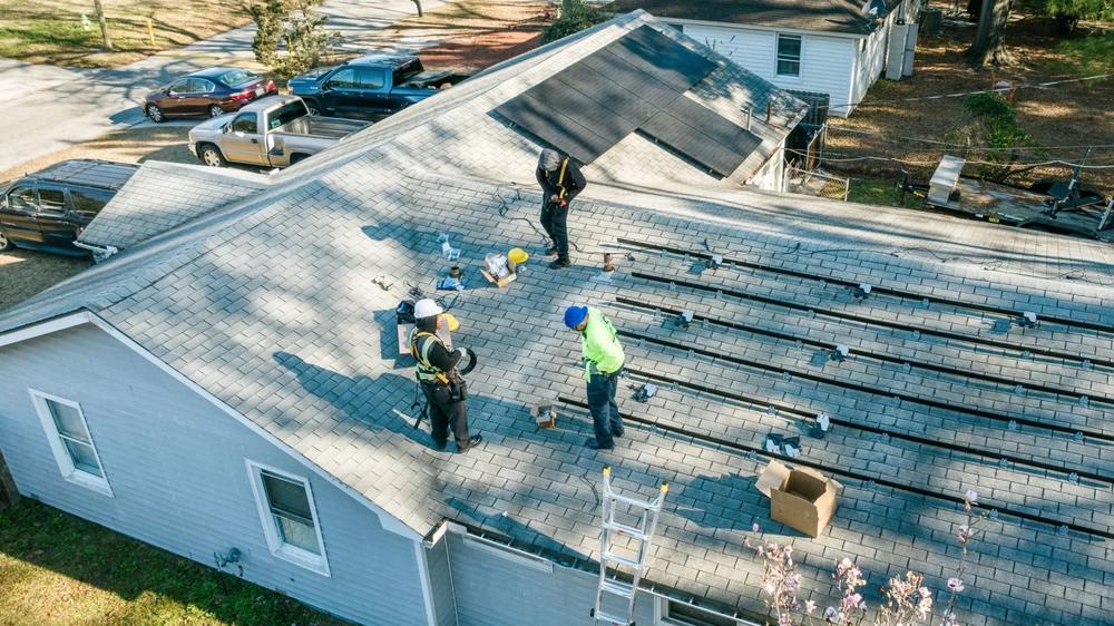 Workers with Be Smart Home Solutions install solar panels on a home in Garden City. Credit: Justin Taylor/The Current