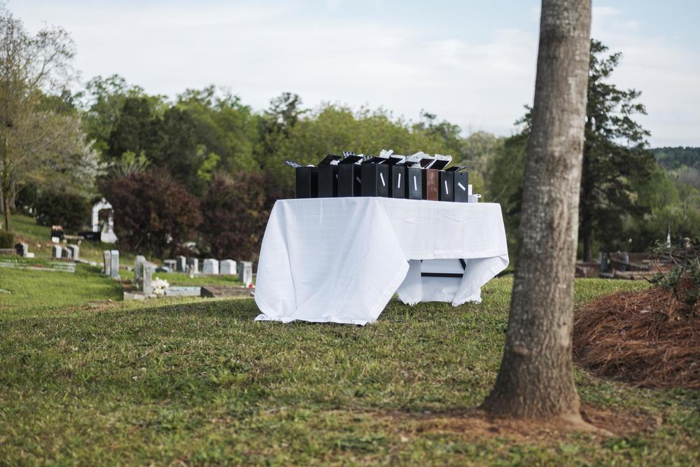 Each box on this table contained the remains of a human being.