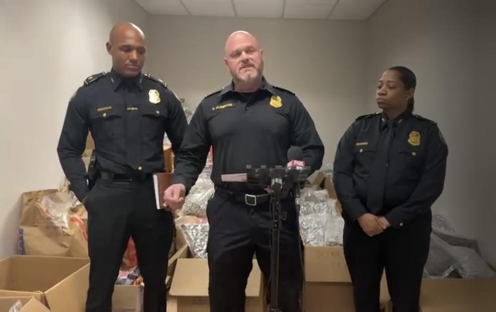 Lt. Robert Albertini and other Atlanta Police officials stand in front of the large seizure of marijuana from an apartment in Buckhead.