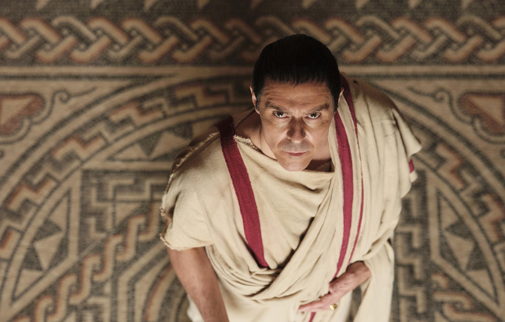 An overhead shot of a man dressed as Julius Caesar.