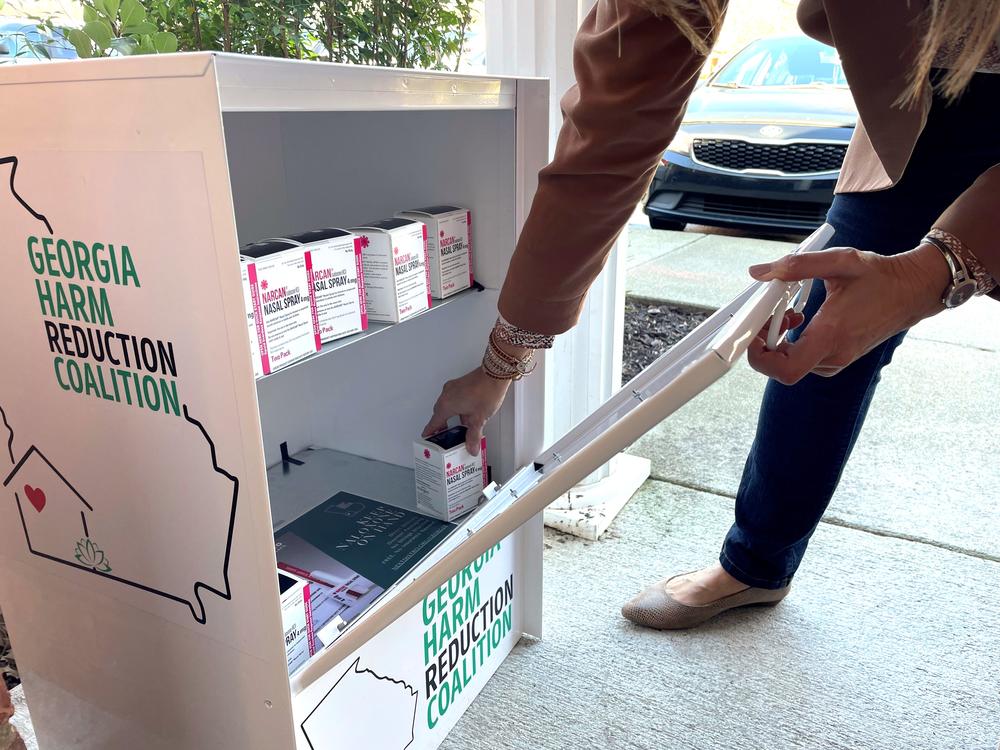 A person grabbing a box of Narcan from a free dispensary