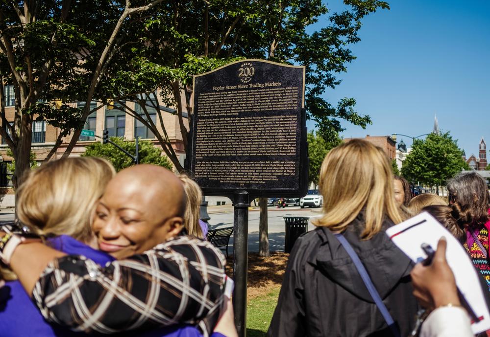 A new historical marker on Macon's Poplar Street describes the slave market on the site of the brick building in the left background of the image which at one time recently was a yoga studio.