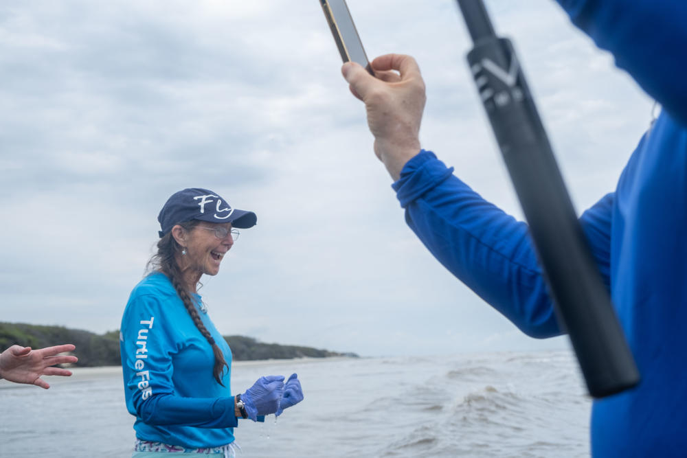 Pilot with Turtles Fly Too, Terry Carbonell, celebrates a successful release of a Kemp's ridley sea turtle into the waters off Jekyll Island.