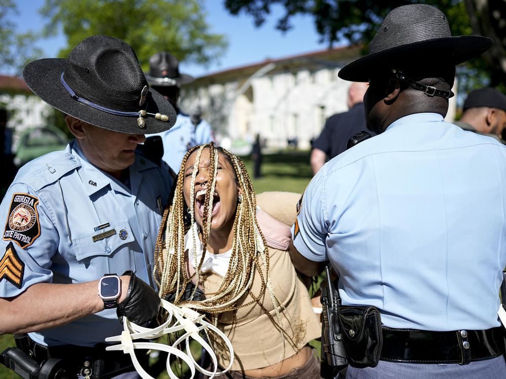 Georgia State Patrol officers detain a demonstrator on the campus of Emory University in Atlanta during a pro-Palestinian demonstration on Thursday. / AP