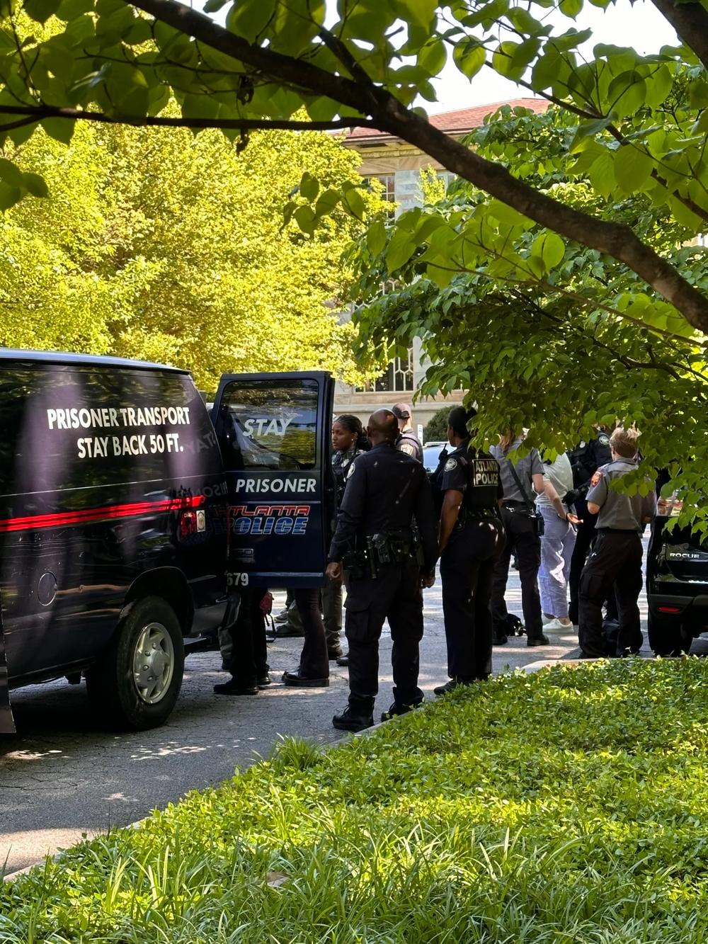 Atlanta Police load arrested protesters into the back of a van at Emory University.