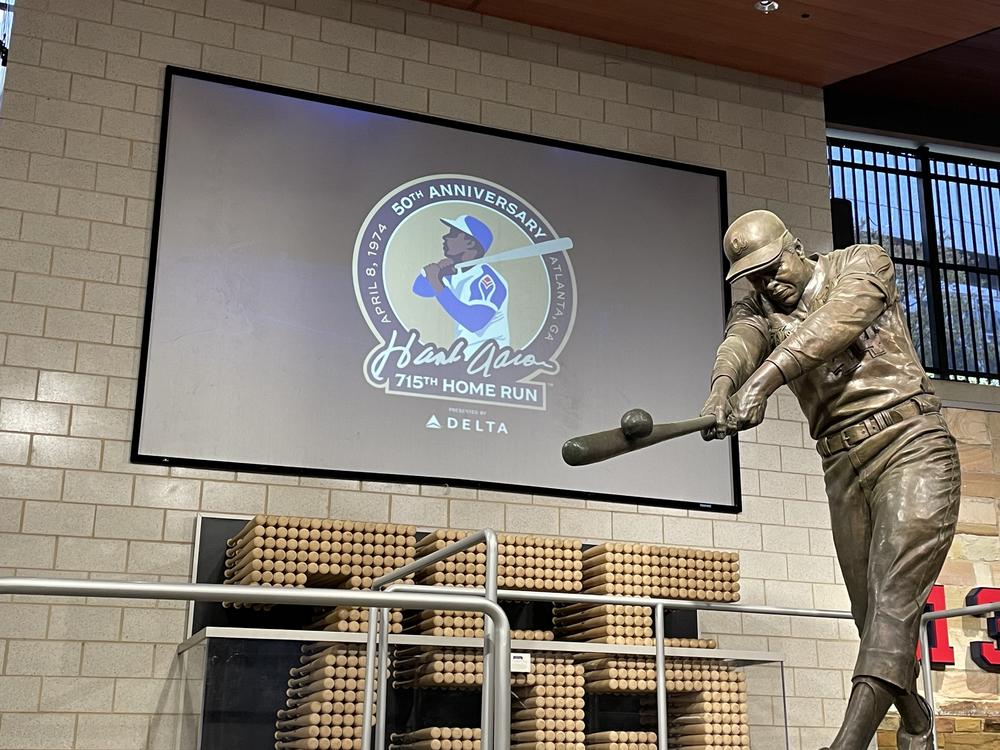 A statue of Hank Aaron inside Truist Park commemorates his incredible career. The Atlanta Braves will honor the 50th anniversary of Aaron's historic 715th home run with special promotions and ceremonies on April 8, 2024.