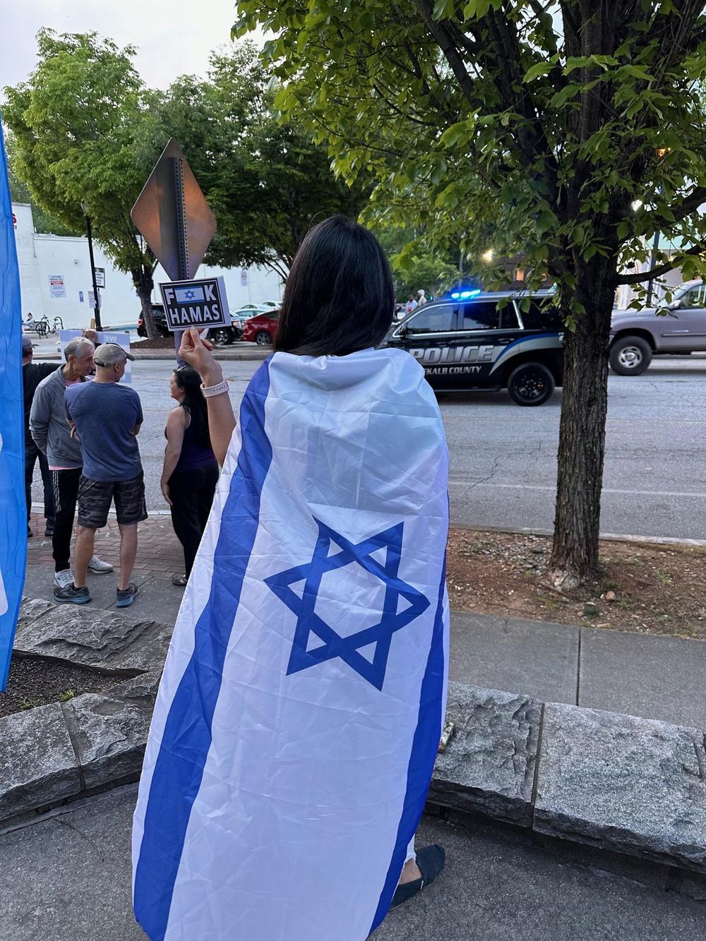 A woman wrapped in an Israeli flag in Emory Village on April 25.
