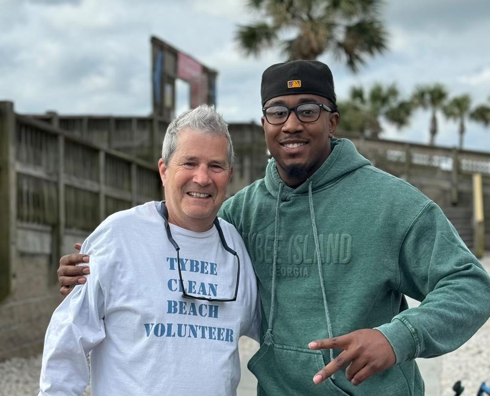 Savannah activist and volunteer Jaydon Grant, right, poses for a photo with Fight Dirty Tybee organizer Tim Arnold during a beach cleanup on Tybee Island after this year's Orange Crush gathering.