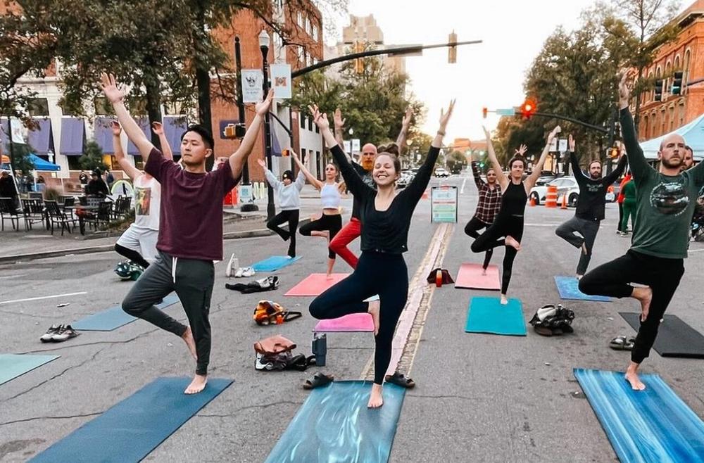 Sparks Yoga leads a free yoga class during Play Streets Macon held during November First Friday in 2023.