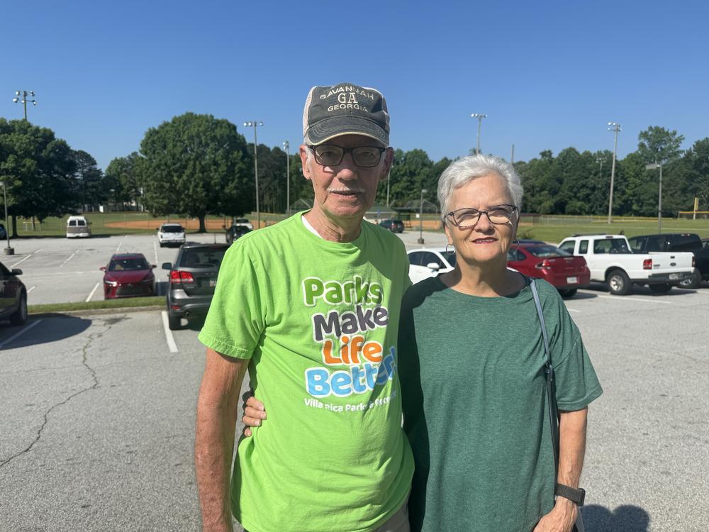 Danny and Lane Camp are shown in a parking lot in this posed photo.