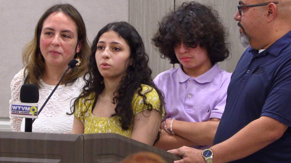 Ella Velez, center, speaks during a Thursday afternoon press conference at Piedmont Columbus Regional Hospital in Columbus, Georgia. With her are her mother, Lorna Velez, brother Alex Velez, and father Luis Velez.