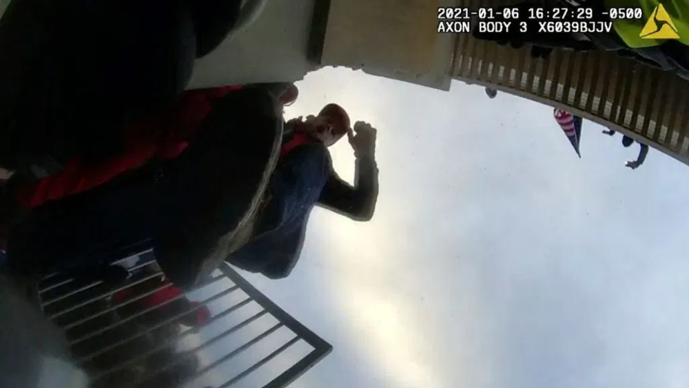 Body camera footage shows men around barricades.