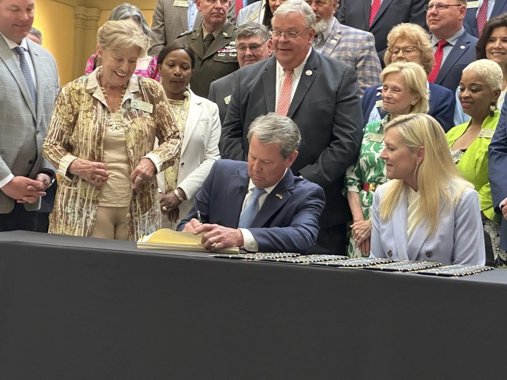 Georgia Gov. Brian Kemp signs the budget for the year beginning July 1, 2024 at the state capitol in Atlanta on Tuesday, May 7, 2024. Kemp says the document shows Georgia can boost spending and cut taxes at the same time.