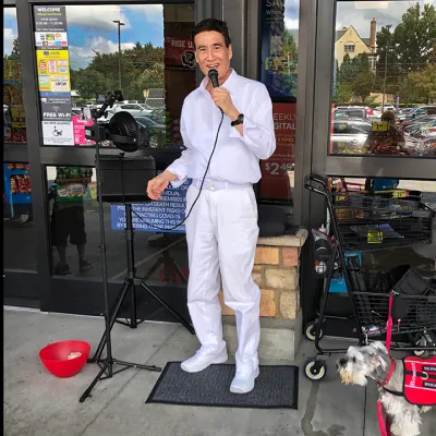 Robert Kim sings outside of the Brookhaven Kroger outside of Cherokee Plaza.