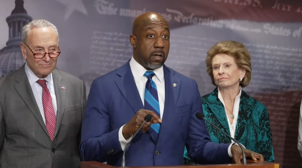 Sen. Raphael Warnock (middle) at a May 23 news conference shortly after Senate Republicans failed to allow debate for the Border Act legislation.