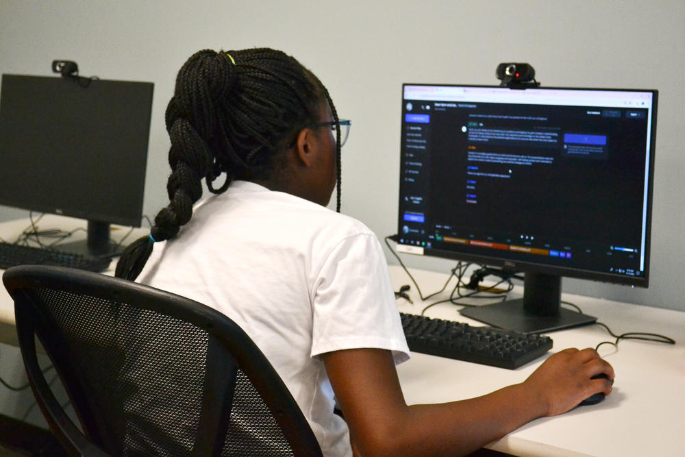 Christabelle Kubuye has a conversation with an AI. She uses what she’s learned so far at camp to prompt it effectively.
