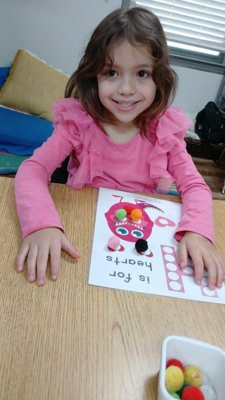 Mireloi Reis' 5-year-old daughter Aysha is shown smiling and playing at Creative Labs Learning Center in Alpharetta, Ga.