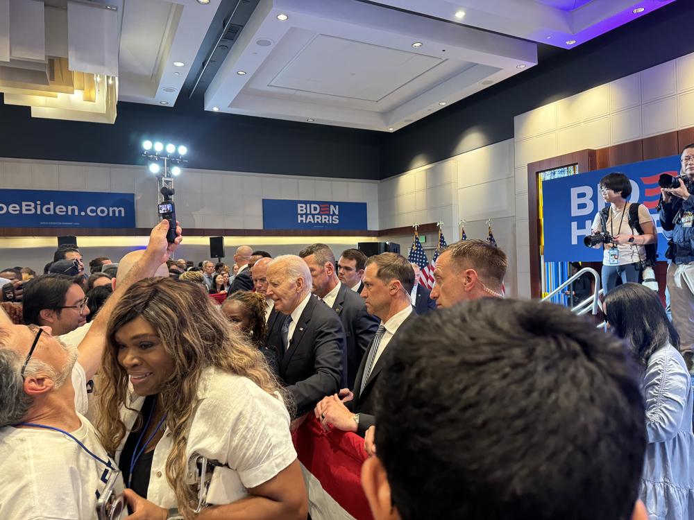 President Joe Biden (center) enters a watch party at 11:00 p.m. after leaving CNN in Midtown Atlanta after the presidential debate on June 27, 2024.