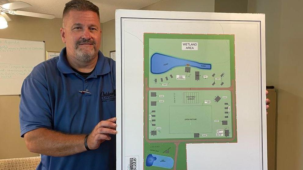 Randy Nichols hold up plans for a campus dedicated to people in drug and alcohol addiction recovery.