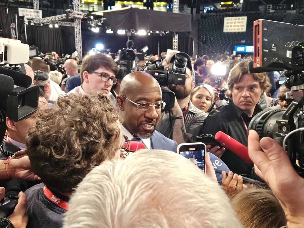 Sen. Raphael Warnock praises President Joe Biden’s debate performance in the spin room at the McCamish Pavilion. Ross Williams/Georgia Recorder.