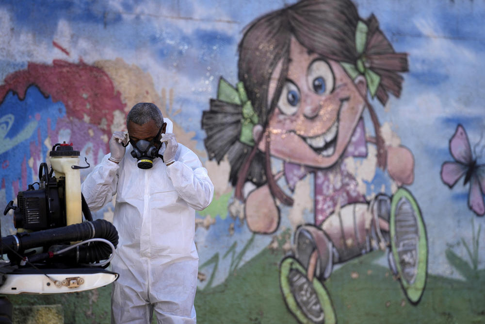 A man prepares to spray for mosquitoes 