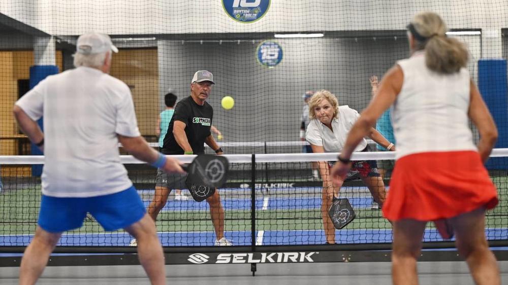 Tony Martinez, 71, left, and Joanna Crawford, 65, from Thomaston, Georgia, compete in mixed doubles on the second day of the United States Senior Pickleball Indoor National Championships on Saturday, July 13, 2024, at Rhythm and Rally Sports & Events in Macon, Georgia. United States Senior Pickleball hosted its inaugural indoor national championships this year, spanning three days and bringing hundreds of seniors to compete in Macon from across the country. KATIE TUCKER/THE TELEGRAPH