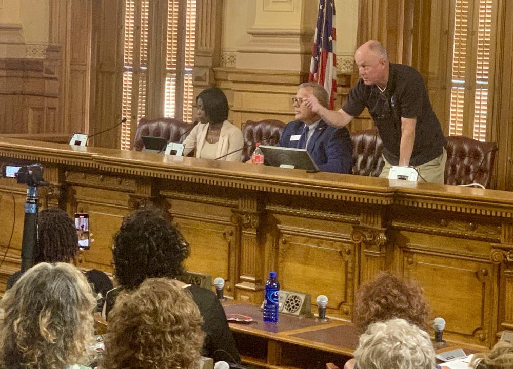  Protesters lodged accusations of open meetings violations at three conservative State Election Board members on July 12. Board member Rick Jeffares, right, responds by threatening to remove people for being disruptive while Janelle King (left) looks on. Stanley Dunlap/Georgia Recorder 
