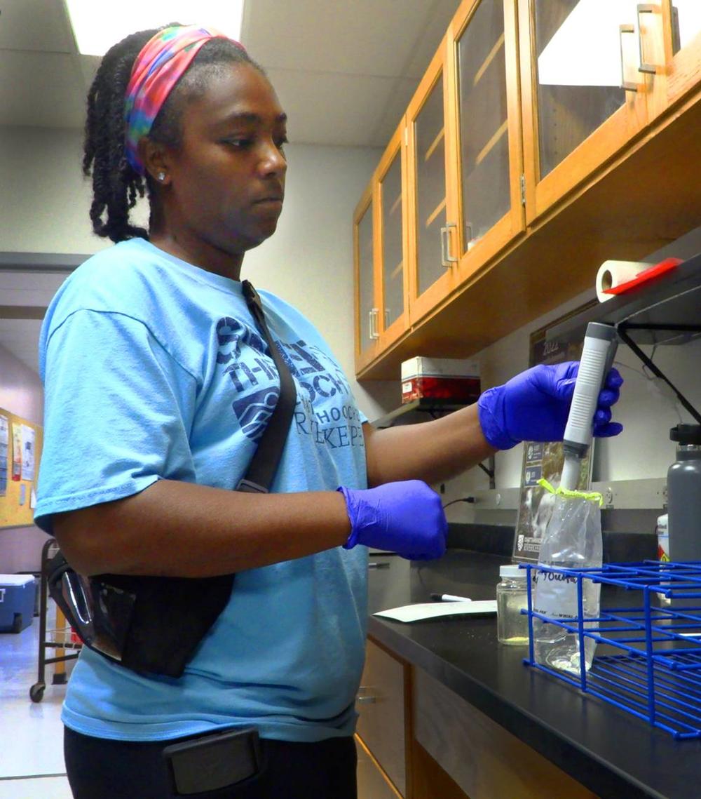 Vanisha Estrahota, Columbus technical programs fellow, tests a water sample she collected from the Chattahoochee River near the outfall pipe for Phenix City, Alabama’s wastewater treatment plant. 07/10/2024 Mike Haskey/Ledger-Enquirer