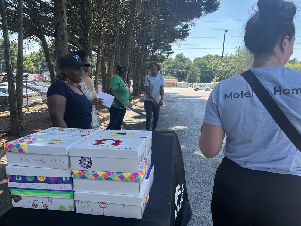 Volunteers with Frontline Housing hand out hygiene kits full of supplies at motels in South Atlanta as part of their monthly outreach services.