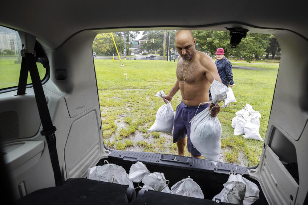 Savannah resident Roi Roizaken loads sandbags into his van as rain from Hurricane Debby starts to fall, Monday, Aug. 5, 2024, in Savannah, Ga. Forecasters warned heavy rain could spawn catastrophic flooding in Florida, South Carolina and Georgia.