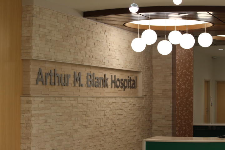 A brick wall with sign that says "Arthur M. Blank Hospital"