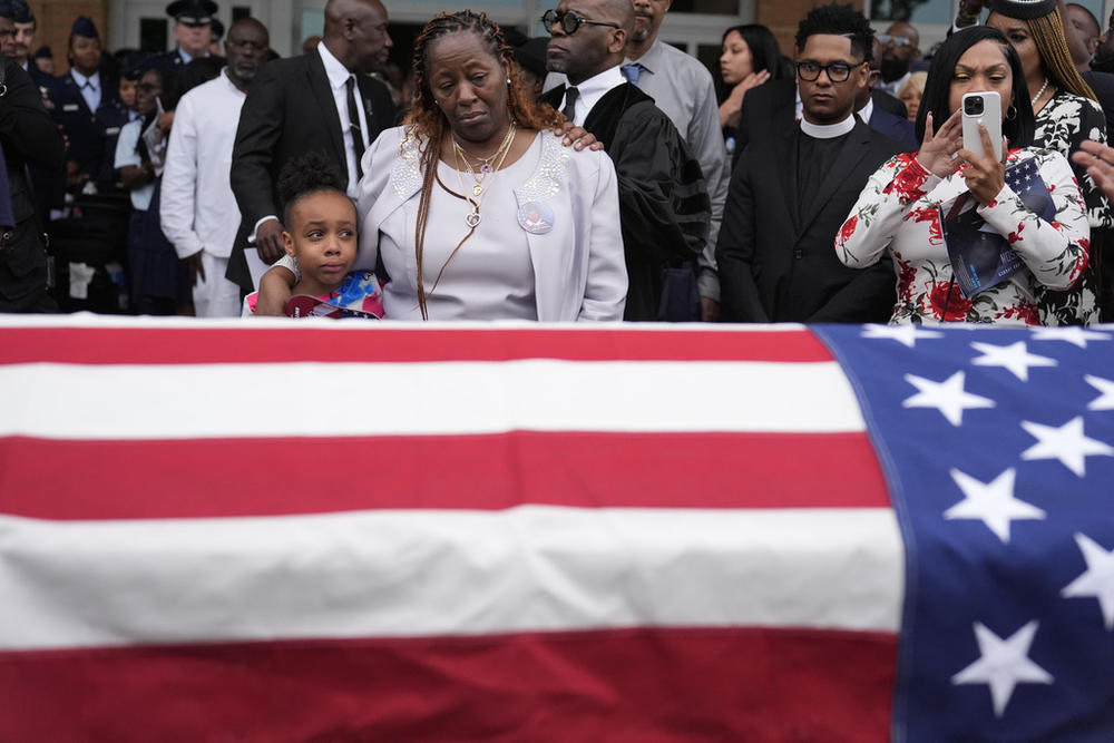 Chantemekki Fortson the mother of slain airman Roger Fortson, right, along with family watch Fortson's casket as they leave for a cemetery during his funeral at New Birth Missionary Baptist Church, on May 17, 2024, in Stonecrest, Ga.