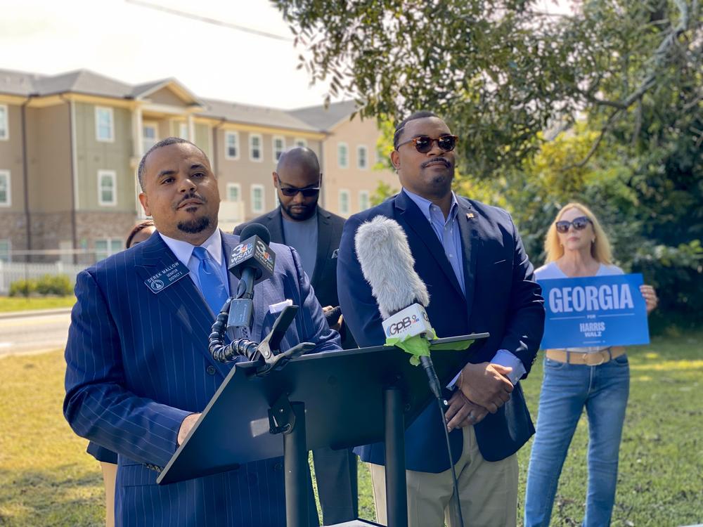 Georgia State Senator Derek Mallow, at left, speaks during a news conference in Savannah on Aug. 27, 2024, about Vice President Kamala Harris's housing affordability plans.