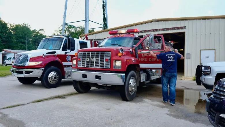 Midway Volunteer Firefighter Harley Keefer cleans a fire engine, July 22, 2024. Credit: Robin Kemp/The Current GA