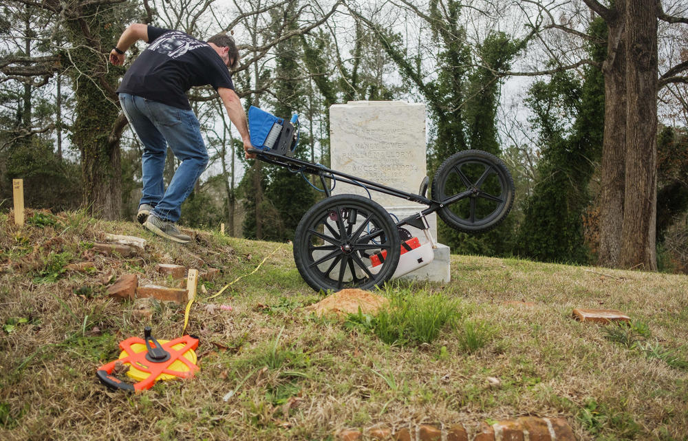 Quinn Connally runs his ground penetrating radar rig over one of the known graves in the Oak Ridge Cemetery in February of 2023. 