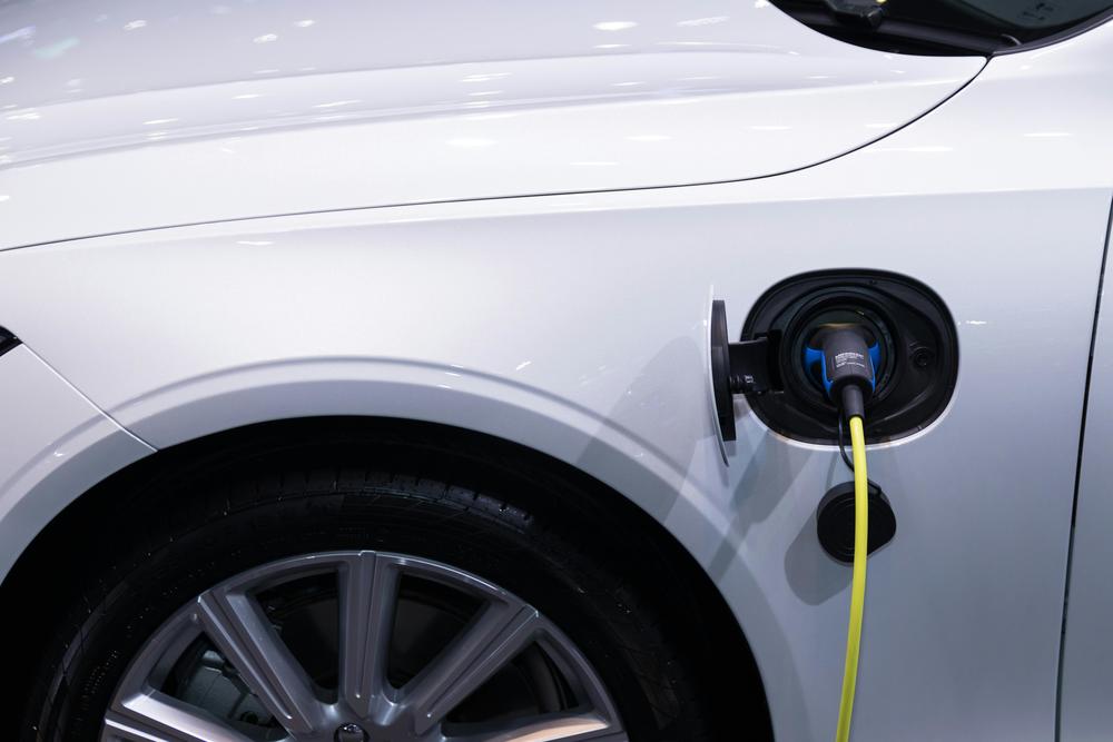 White car charging. Sens. Warnock and Ossoff announced they are delivering Federal funding to build more EV chargers throughout Georgia. (Pexels)