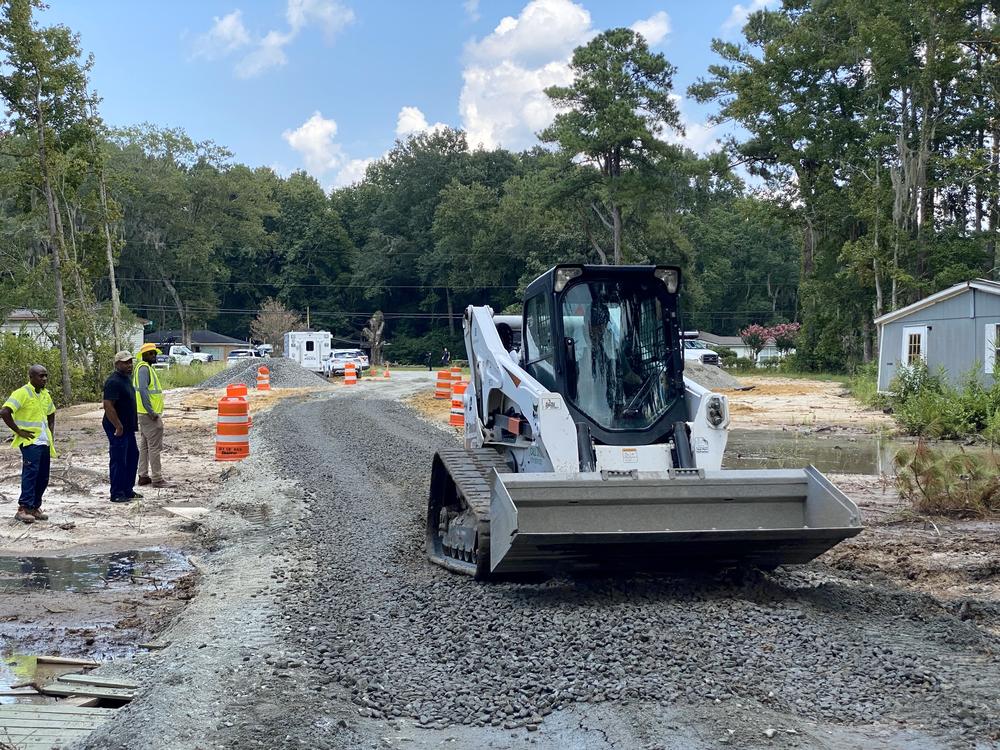 A compact track loader clears a temporary road in southwest Savannah's Bradley Point neighborhood on Monday, Aug. 12, 2024.