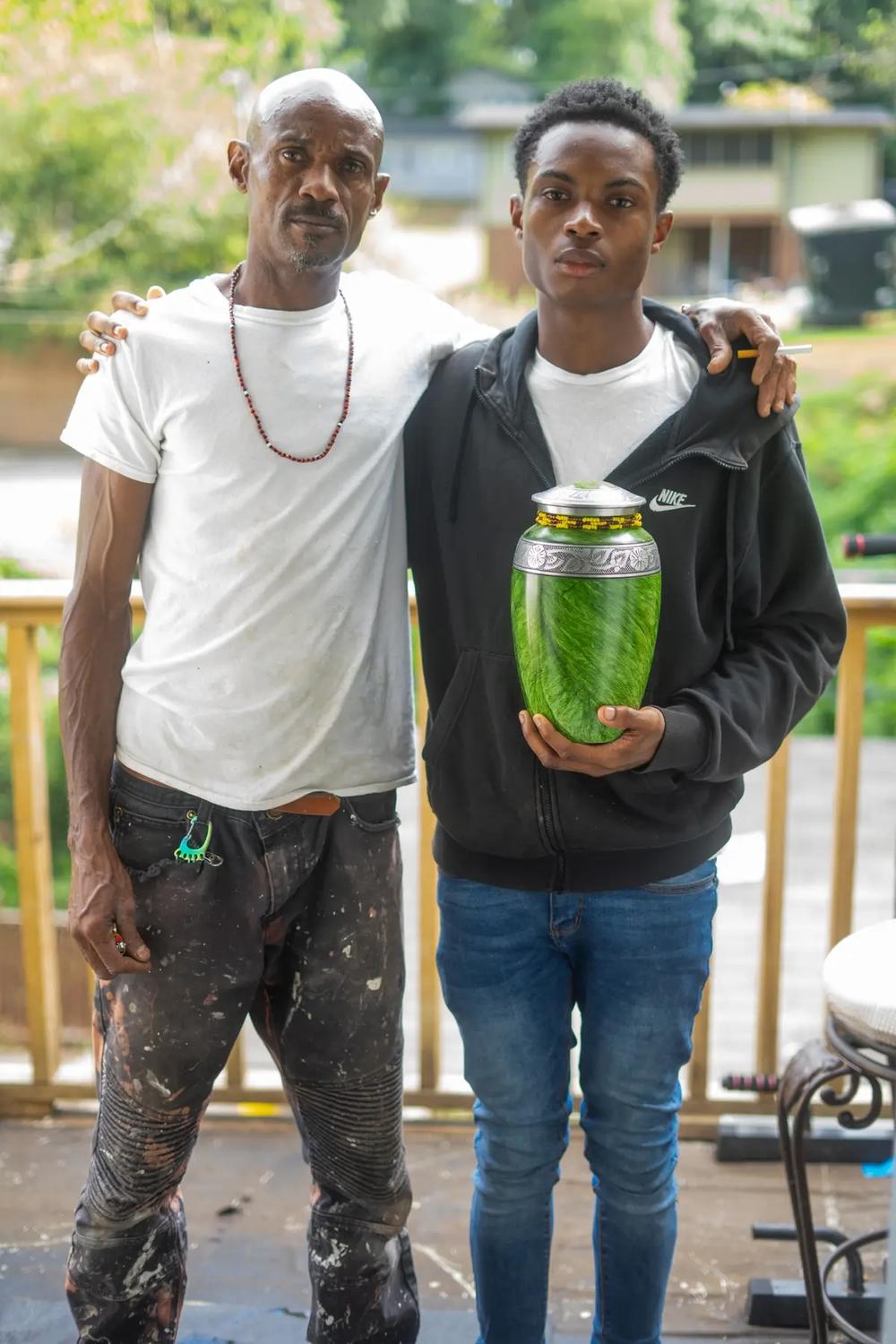 Miller’s husband, Alex, and son Christian, with her ashes, at home in Atlanta Credit: Rita Harper, special to ProPublica